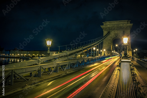 night old street and bridge with lantern lights and long exposure near waterfront district