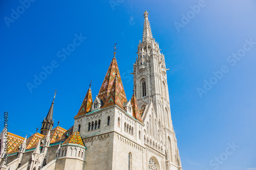 white beautiful gothic church facade in bright summer day on blue sky background with empty space for copy or text