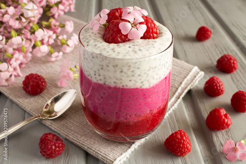 Pudding with chia and raspberries on the grey wooden background