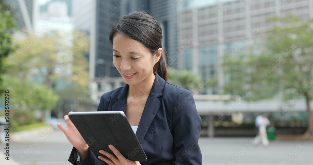 Businesswoman check on tablet computer at outdoor Businesswoman check on tablet computer at outdoor