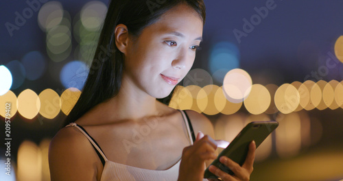 Young Woman use of smart phone at night