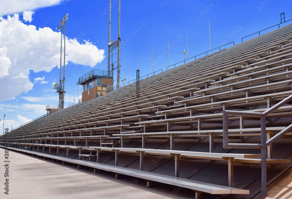 Fototapeta premium Stadium Bleachers with Blue Sky and Clouds