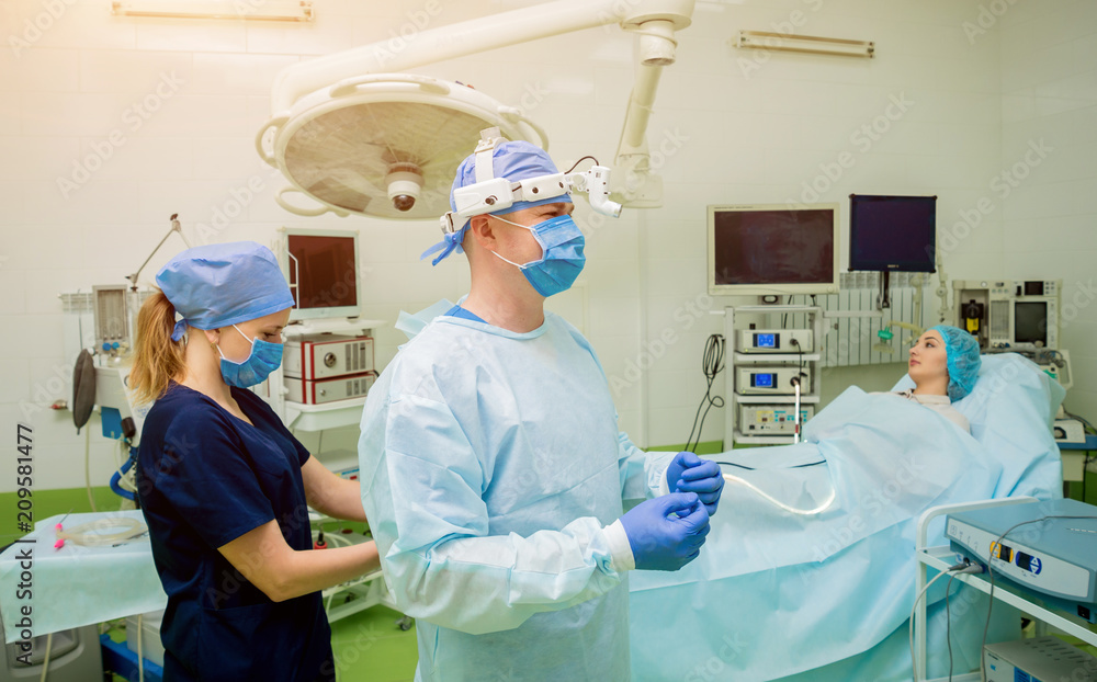 Portrait of surgeon in modern procedure room. Background Portrait of surgeon in modern procedure room. Background