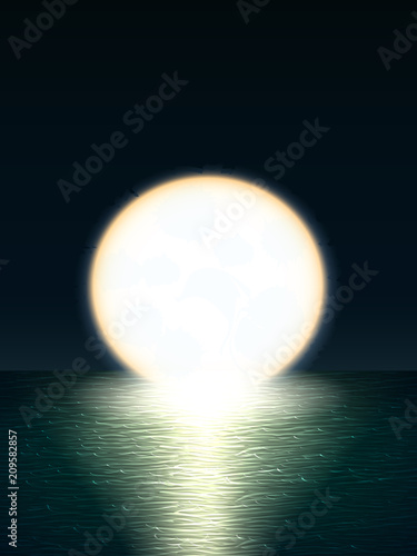 Giant yellow full moon over the sea at sunset or sunrise