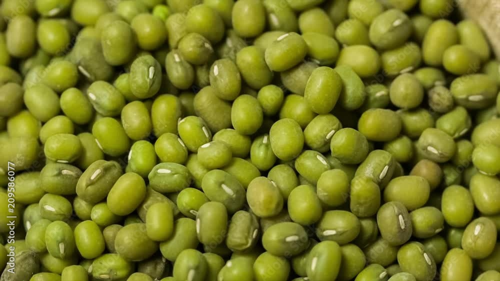 Green mung bean in wooden bowl. Macro. Turntable rotating shot. Close up. Top view Green mung bean in wooden bowl. Macro. Turntable rotating shot. Close up. Top view