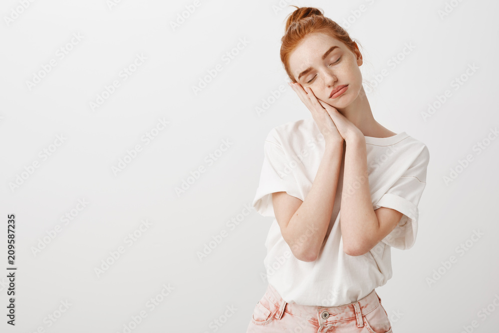 Just give me sec to sleep. Portrait of calm and cute natural redhead female in stylish modern outfit, leaning on palms as if sleeping with closed eyes, dreaming, being tired after university Just give me sec to sleep. Portrait of calm and cute natural redhead female in stylish modern outfit, leaning on palms as if sleeping with closed eyes, dreaming, being tired after university