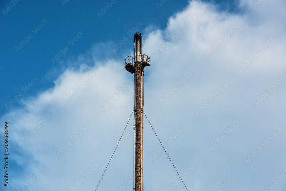 Industrial chimney, which emits smoke into the air.