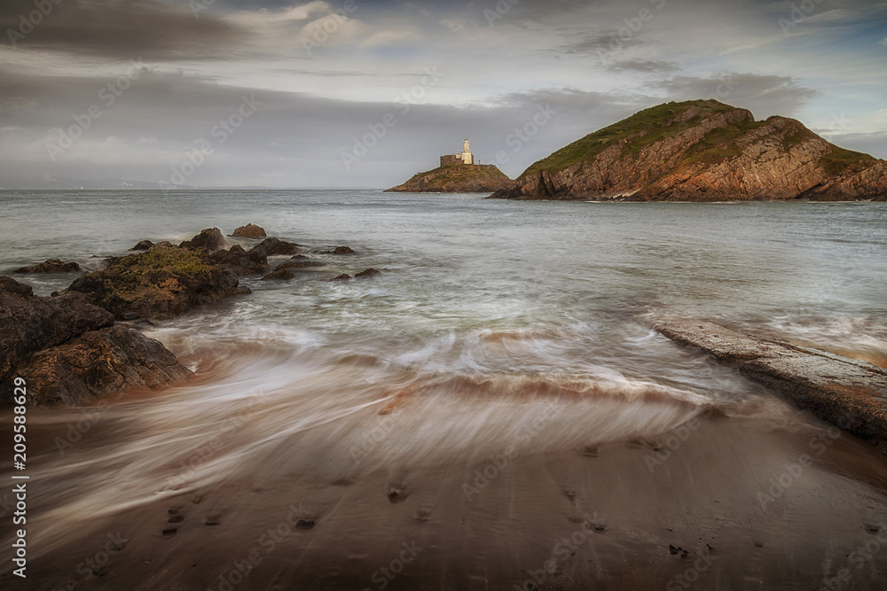 Receding ocean waves at the old concrete slipway at Mumbles beach and lighthouse, Swansea, South Wales, UK
Receding ocean waves at the old concrete slipway at Mumbles beach and lighthouse, Swansea, South Wales, UK