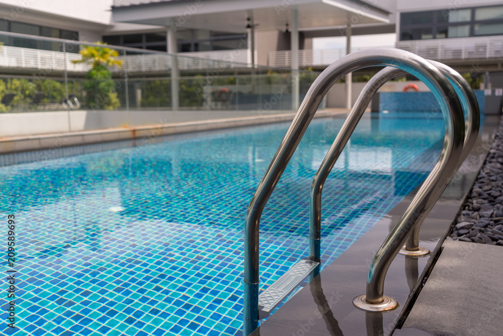 Beautiful luxury swimming pool with Pool stair on sunny day Beautiful luxury swimming pool with Pool stair on sunny day