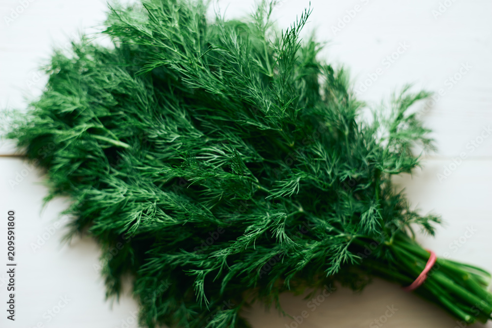 Fototapeta premium Bunch of fresh green dill on the table top view
