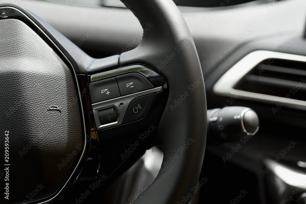 Detail of the steering wheel buttons of a car.