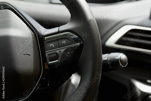 Detail of the steering wheel buttons of a car. © PLG