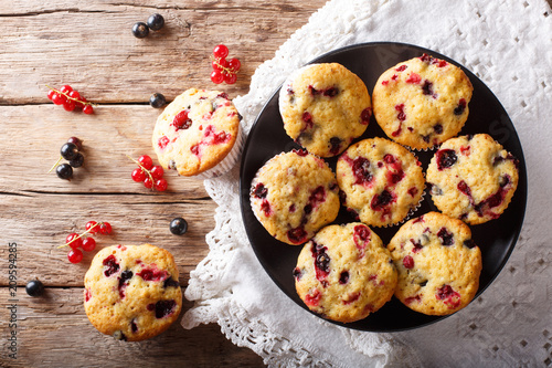 Summer dessert: muffins with a berry mix of currants close-up. Horizontal top view from above