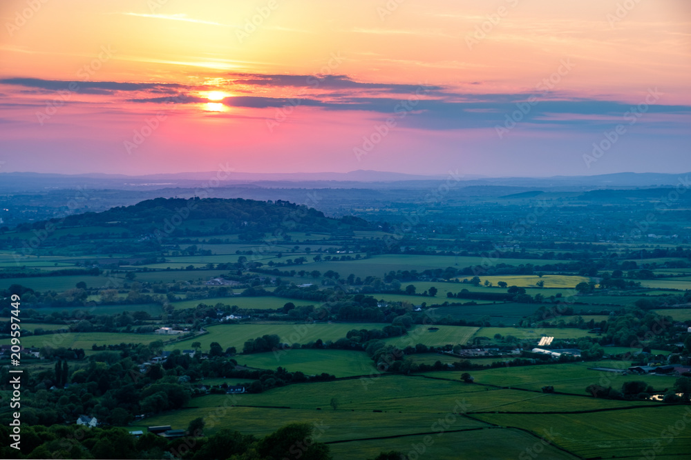 Sunset viewed from Crickley Hill looking towards Gloucester and the hills in the distance.