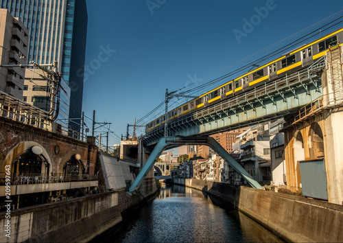 Papier peint Tokyo train crossing a bridge over the Kanda river near Akihabara