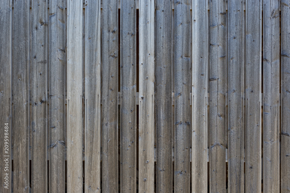 Full frame background of a gray and unpainted wood board wall Full frame background of a gray and unpainted wood board wall