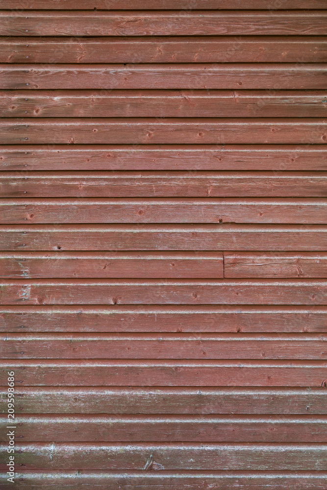Full frame background of an old and faded wood board wall painted in red Full frame background of an old and faded wood board wall painted in red