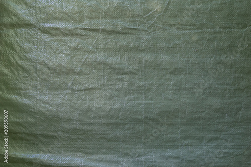 Full frame background of a wrinkled green tarp texture photo