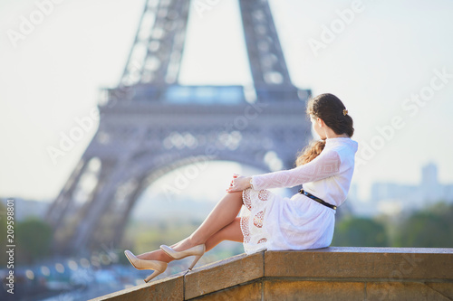 Woman in white dress near the Eiffel tower in Paris, France © Ekaterina Pokrovsky