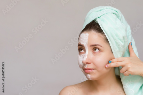 Woman with moisturizing face cream on her face. Face skin care concept.