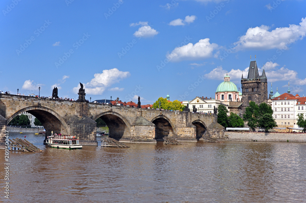 View from the Vltava River to Charles Bridge, the Old Town Tower and the Church of St. Francis of Assisi. Prague, Czech Republic, Europe, UNESCO.