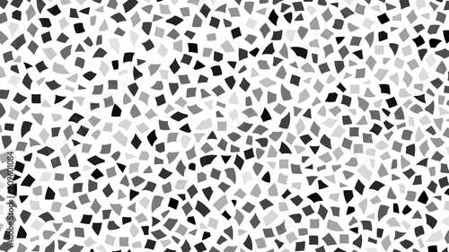 Abstract backdrop of small black and gray pieces of paper or splinters of ceramics on white background