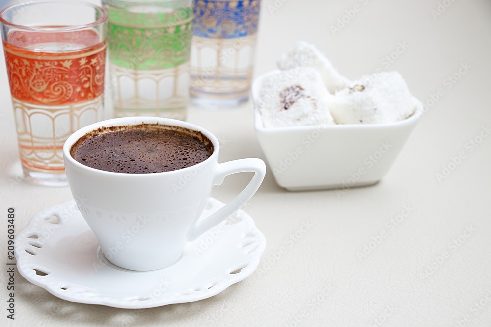 Turkish coffee with milk cream chocolate pistachio Turkish delight and cup of water Turkish coffee with milk cream chocolate pistachio Turkish delight and cup of water