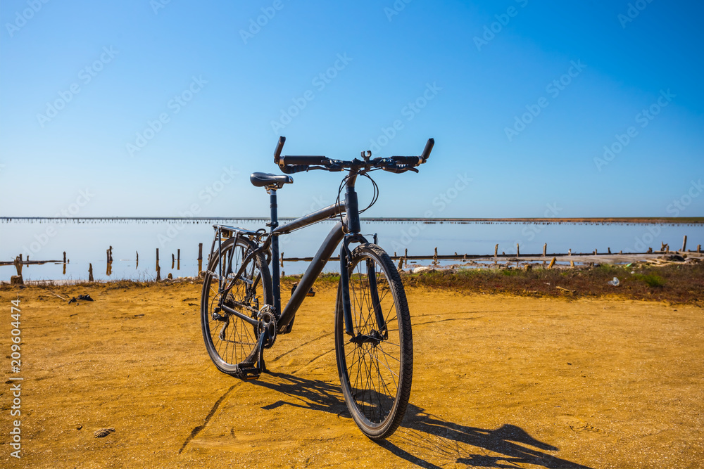elegant bicycle stay on a sandy lake coast elegant bicycle stay on a sandy lake coast
