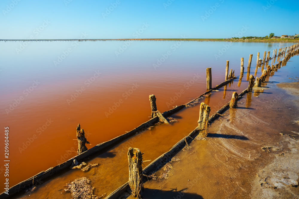 red saline lake with remains of an old constructions