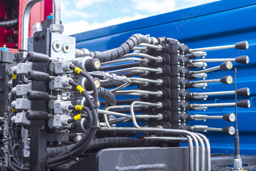 Close up of pipe system of hydraulic valves in agricultural machinery