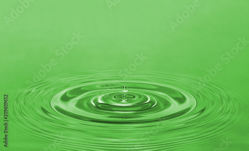 a drop of water on a green background