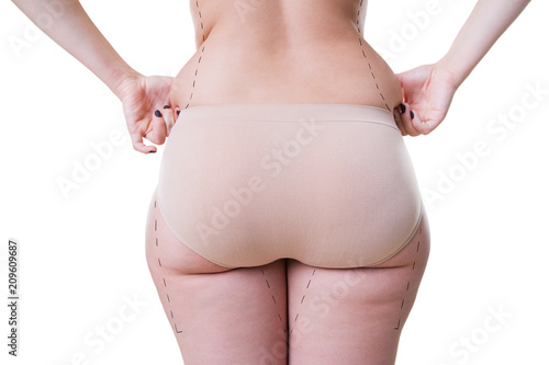 Woman holding fold of skin, cellulite on female body isolated on white background photo