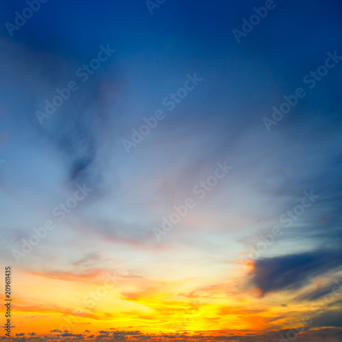 Cloudy sky and bright sun rise over the horizon.