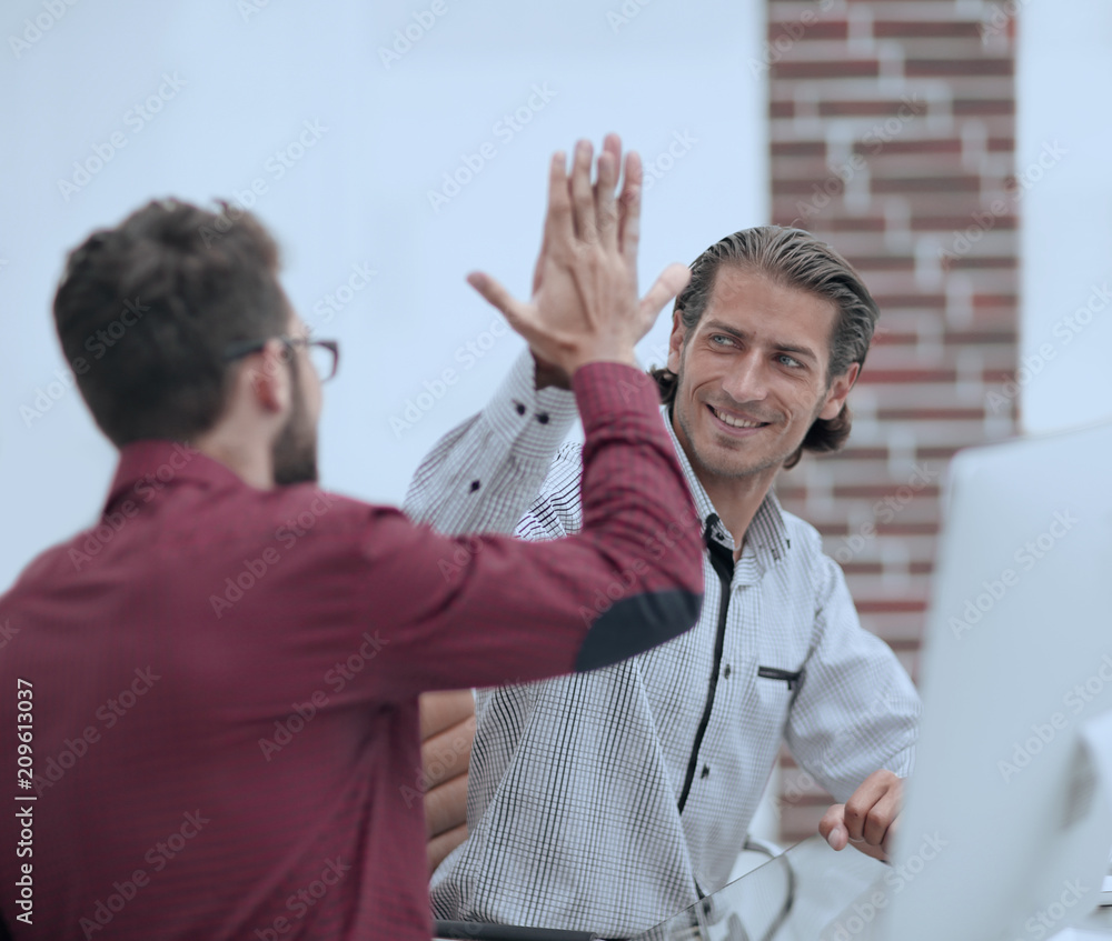Businessman giving high five to his partner Businessman giving high five to his partner