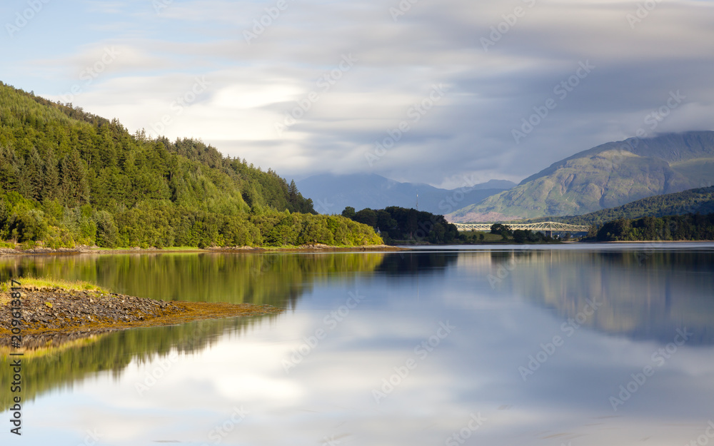 Loch Leven.  A long exposure of the view across Loch Leven from Ballachulish towards Ballachulish Bridge in the Scottish highlands.  Loch Leven is a sea loch on the west coast of Scotland.