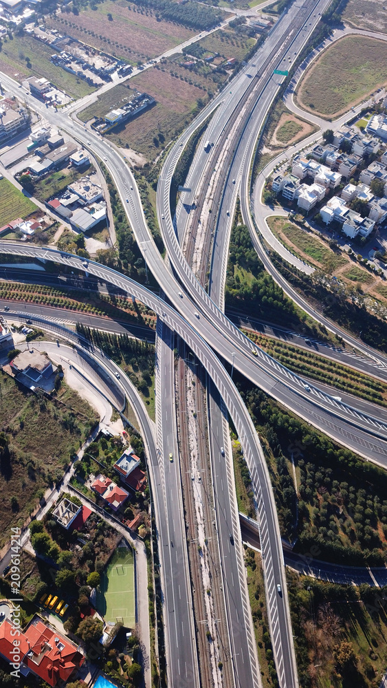 Aerial drone bird's eye view of popular highway of Attiki Odos multilevel junction road, passing through National motorway in traffic jam, Attica, Greece