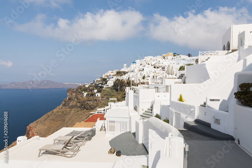 View over Aegean sea, Firostefani village and volcano caldera with luxury hotel on the foreground