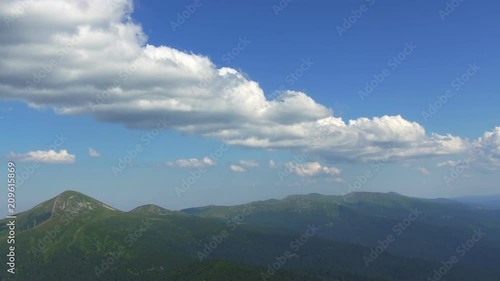 Time-lapse of beautiful summer landscape in mountains with clouds passing by against blue sky. Time-lapse of beautiful summer landscape in mountains with clouds passing by against blue sky.