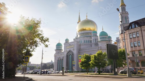 Slow motion shooting of Moscow Cathedral Mosque. The sun is shining through the branches. Golden dome of the biggest islamic church in Europe is sparkling in the rays of sun.