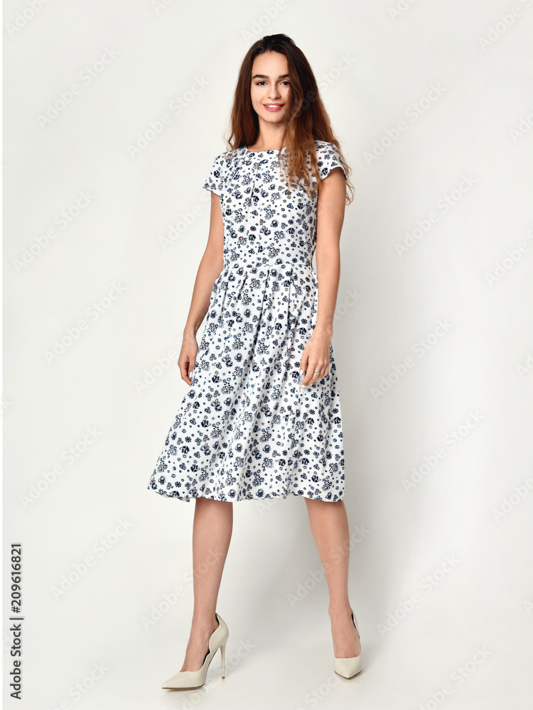 Young beautiful woman posing in new design casual summer dress on grey 
