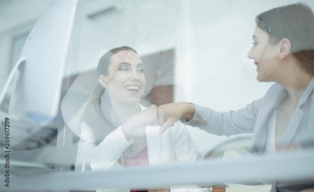 behind the glass.colleagues celebrate their success behind the glass.colleagues celebrate their success