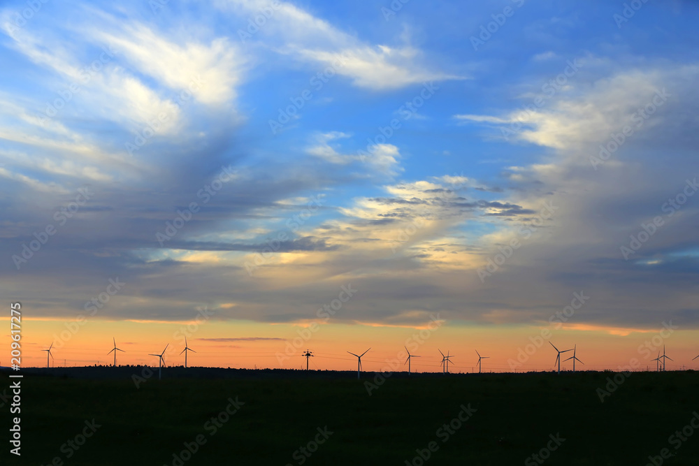 The silhouette of the windmill in the sunset