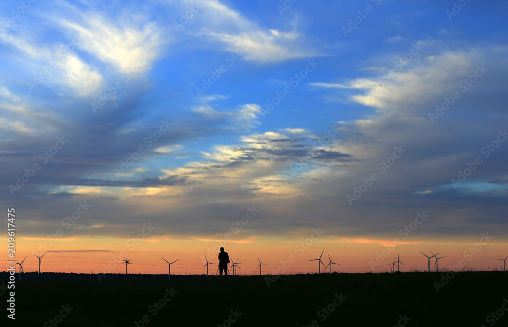 The silhouette of the windmill in the sunset