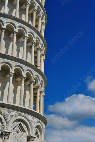 The famous Leaning Tower of Pisa among beautiful clouds (with copy space)