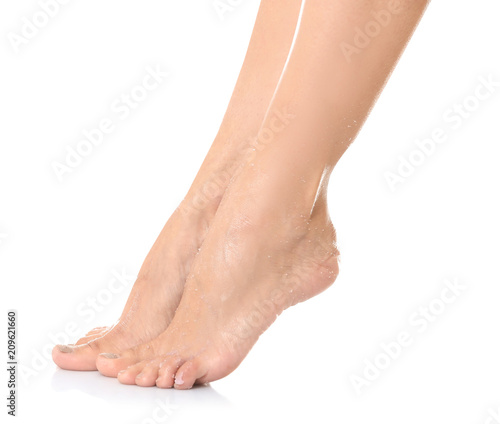 Female legs with applied natural scrub against white background © New Africa