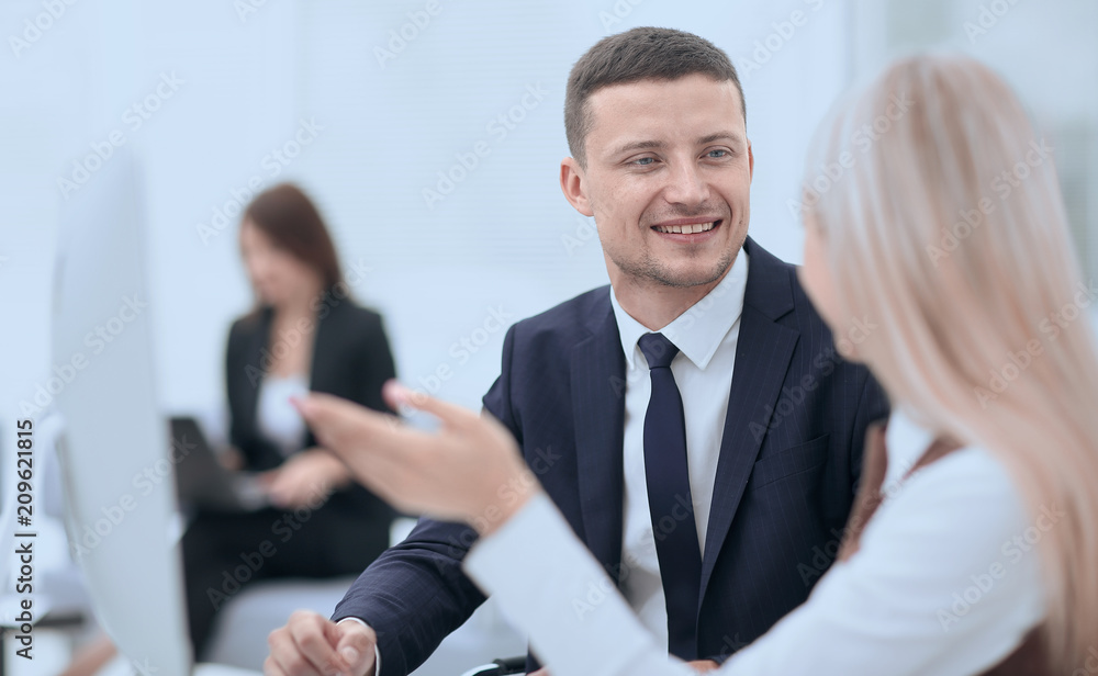 Fototapeta premium Manager talking with a colleague at the workplace