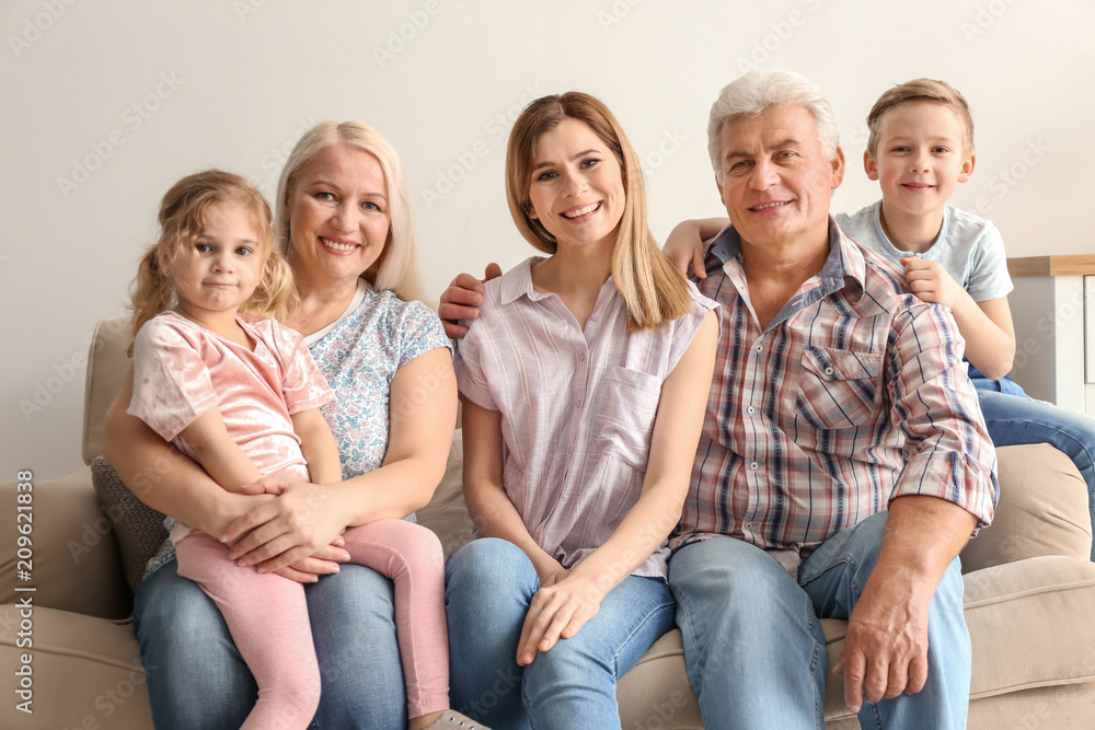 Happy family with cute kids on sofa at home Happy family with cute kids on sofa at home