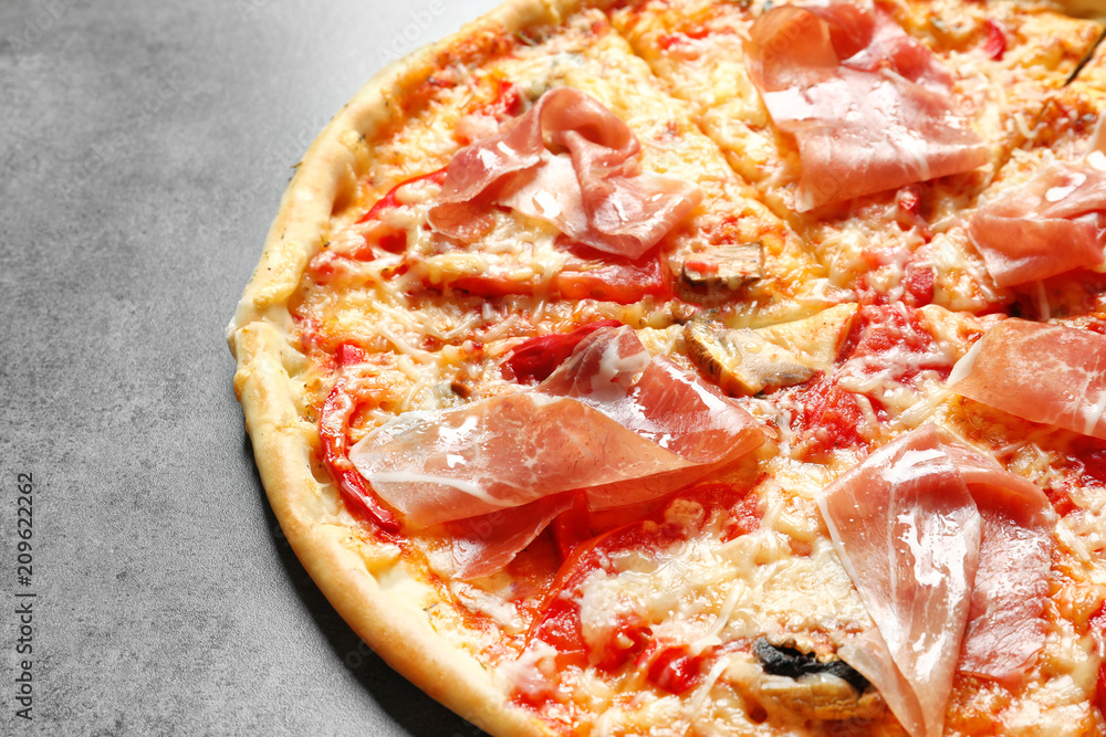 Delicious pizza with bacon on grey background Delicious pizza with bacon on grey background
