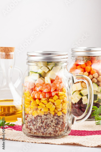 Fresh homemade salad in jars with quinoa, chickpeas and organic vegetables. Healthy take away food, office lunch, vegeterian, detox diet concept.