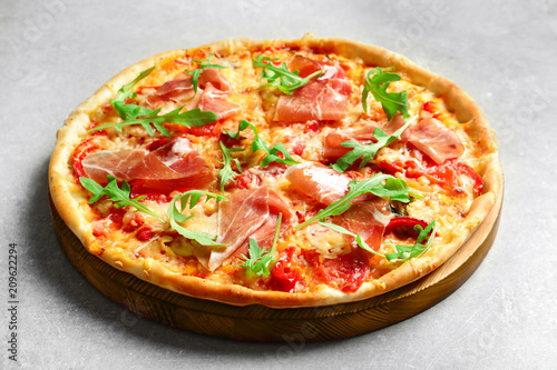 Tasty hot pizza with meat on light background
